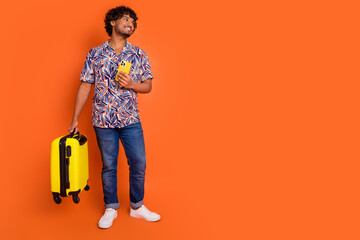 Sticker - Full size photo of nice young man look empty space hold suitcase device wear trendy colorful outfit isolated on orange color background