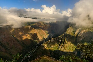 Wall Mural - Aerial view of mountain valley with river and clouds