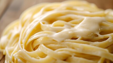 A close up of a plate of pasta with a creamy sauce