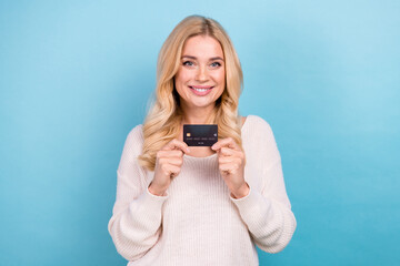 Wall Mural - Photo of charming lovely nice woman wear stylish white clothes hold bank card isolated on blue color background