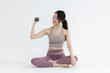 © charnsitr - Isolated asian woman with dumbbell exercise on white background