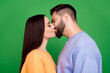© deagreez - Photo of pretty cute adorable couple wear stylish clothes sweet kiss isolated on green color background