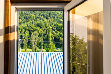 Wall Mural - roof and forest through open window in Dilijan