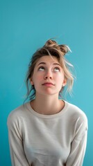 Wall Mural - Young caucasian woman isolated on blue background