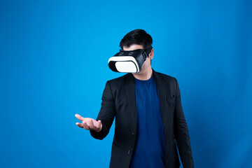 Wall Mural - Profile of businessman wearing VR device connecting metaverse, holding stuff in the air isolated blue background futuristic analytics communication technology virtual reality copyspace. Contrivance.