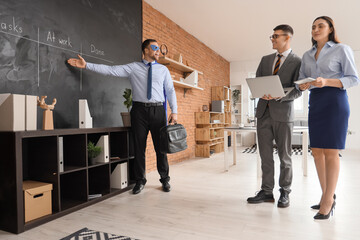 Canvas Print - Business man dressed as superhero giving presentation to his colleagues in office