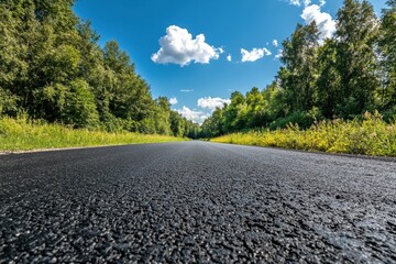 Sunny summer day countryside view on asphalt road