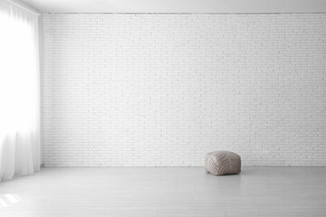 Wall Mural - Soft pouf in stylish empty room