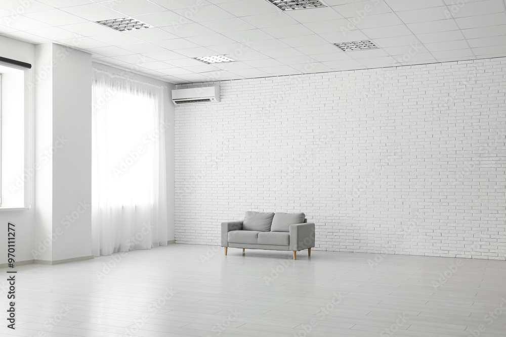 Cozy sofa in stylish empty room