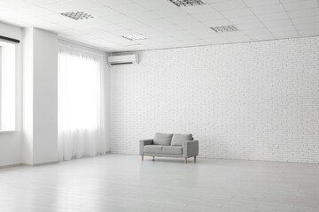 Wall Mural - Cozy sofa in stylish empty room