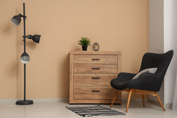 Sticker - Chest of drawers, armchair and floor lamp near beige wall in room