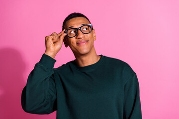 Wall Mural - Photo of cheerful positive guy dressed pullover arm eyewear looking emtpy space isolated pink color background