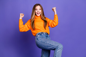 Wall Mural - Portrait photo of youth charming blonde hair cute happy smile girl winning team fan raised fists up isolated on violet color background