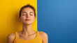 © iamfrk7 - Woman meditating in yellow top against bright yellow background, highlighting mindfulness, inner peace, and relaxation for mental clarity and personal well-being