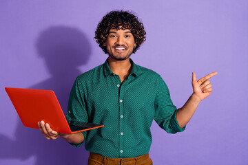 Wall Mural - Photo portrait of funny latin guy programmer index finger his code with wavy haircut wearing green casual shirt isolated on violet color background