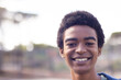 © wavebreak3 - Smiling african american teenage boy outdoors, looking at camera, copy space