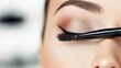 © BOJOShop - Close Up of Woman s Eye with Makeup Brush Applying Eyeliner