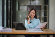 © Kritdanai - Confident Asian Businesswoman Multitasking at Work