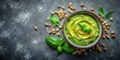 © Theerawat - Fresh Basil Pesto Sauce in Bowl with Pine Nuts and Green Basil Leaves on Dark Rustic Background for Healthy Homemade Vegan Recipe, Mediterranean Cuisine, and Flavorful Herb Dip Concept