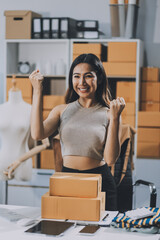 Wall Mural - Successful Woman start up online seller at workplace. small business entrepreneur SME or freelance asian woman working with box at home.