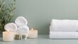 © Peter@studio5 - A soft and serene spa setup with white towels, herbal sachets, and candles, white towels, herbal sachets, candles