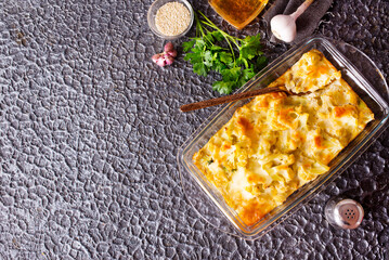 Wall Mural - Cauliflower cheese in a baking dish on stone table