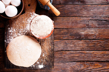 Fresh dough on board with flour