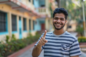 Poster - A man in striped shirt giving thumbs up while standing on street. AI.