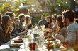 © Worawee - A group of people are gathered around a long table with food and drinks