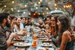 © Worawee - A group of people are gathered around a long table with food and drinks