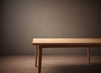 A wooden table with a simple, minimalist design sits in a dimly lit room, its surface reflecting the soft light.