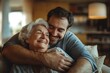 © Marina Shvedak - Happy caregiver embracing senior woman in room at home indoor