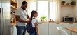 © Reubens Stock Photos - Caring African American Dad Assisting Young Daughter to Prepare for a School Day