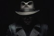 © Yeivaz - Shadowy silhouette of a man wearing a stylish hat and coat stands against a deep and dark background