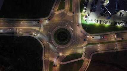 Wall Mural - Aerial footage of the cars driving on roundabout on the Highway 85 at night in Waterloo, Canada