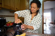 © Taras Grebinets - Woman making fresh juice in kitchen with citrus fruit and blender on a sunny morning