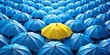 © Fist - a collection of blue umbrellas with a single yellow umbrella