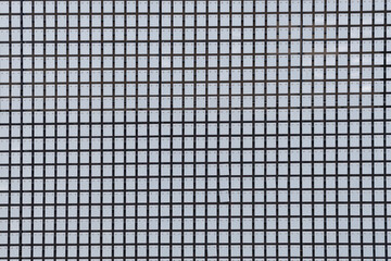 A grid of square tiles forming a repetitive geometric pattern in light gray tones. Backgrounds