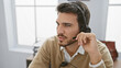 © Krakenimages.com - Handsome hispanic man with beard wearing headset in modern office