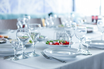 served table, glasses, plates, vase with forge