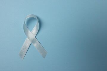 Wall Mural - Light blue ribbon on color background, top view with space for text. Prostate cancer awareness