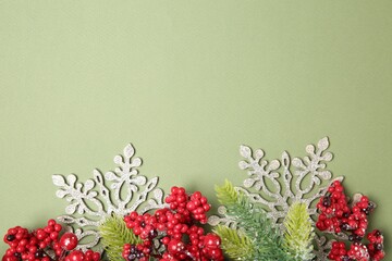 Wall Mural - Flat lay composition with fir tree branches and Christmas decor on green background. Space for text