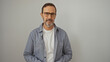 © Krakenimages.com - Handsome mature hispanic man in glasses and casual clothing standing isolated against a white wall background