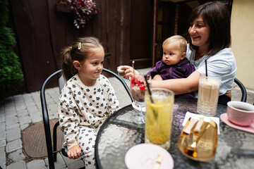 Mother with children enjoying family time at outdoor cafe