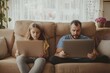 © Nalinthip - A man and a little girl are sitting on a couch, both using laptops