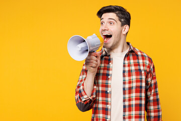 Poster - Young happy man wears red checkered shirt casual clothes hold in hand megaphone scream announces discounts sale Hurry up isolated on plain yellow orange background studio portrait. Lifestyle concept.