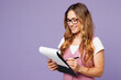 © ViDi Studio - Young successful employee business woman corporate lawyer wear classic suit vest white t-shirt glasses work in office hold clipboard sign paper account documents isolated on plain purple background.