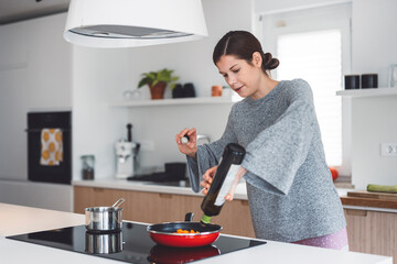 Young mommy cooking healthy vegetable meal for baby. Correct food is crucial for health.