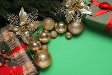 Poster - Different Christmas decor and gift boxes on green background, flat lay. Space for text