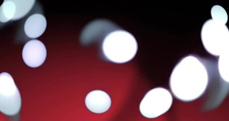 Sticker - Animation of glowing light spots moving over red and black background